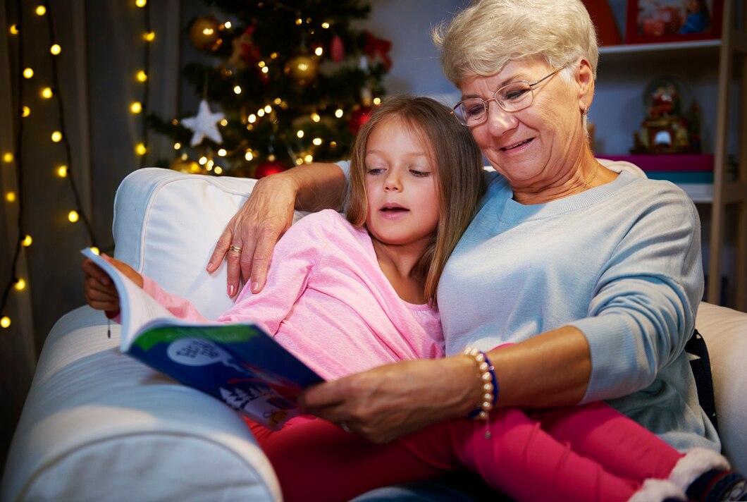 Grandmother reading with her granddaughter in an armchair